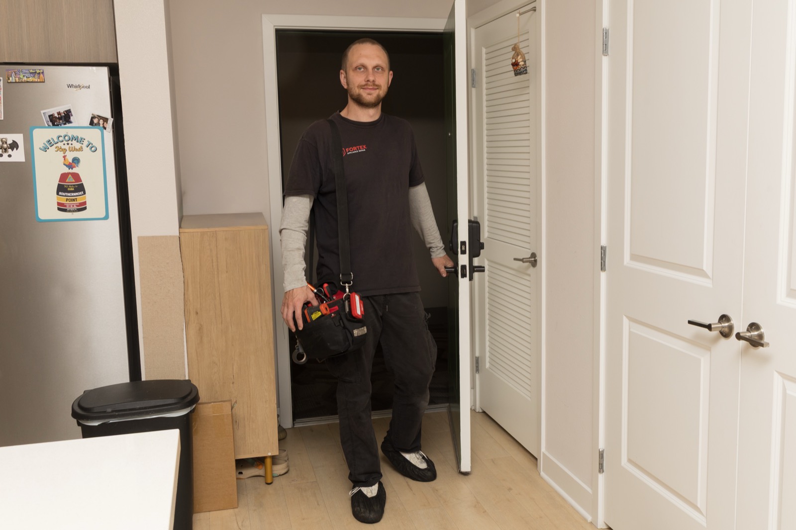Uniformed Fortex technician arriving for a service call with his tool bag
